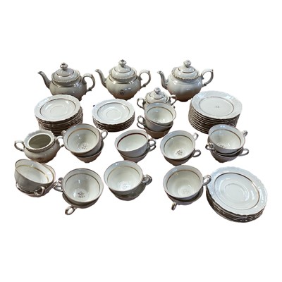 Lot 5112 - Rorstrand Swedish cream and gilt tea set, the rims with raised scroll pattern, comprising three teapots, two sugar bowls and one cover, 11 side plates, 15 saucers, and 21 cups