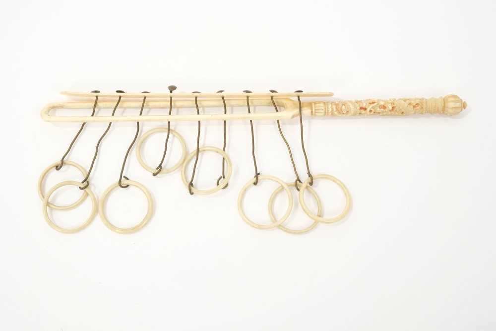 Lot 15 - Rare 19th century Chinese Canton carved ivory Chinese ring puzzle game, with eight suspended rings (one lacking) and carved handle, 23cm long