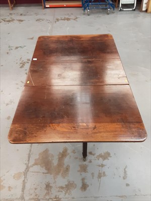 Lot 892 - George mahogany drop leaf table on square legs and brass capped castors