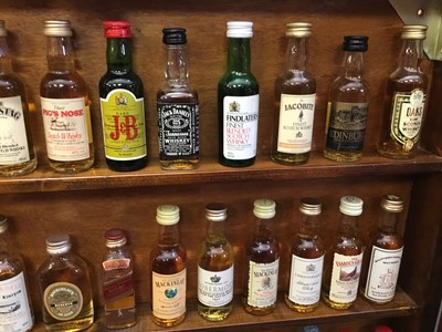 Lot 135 - Collection of miniature spirits in wall cabinet.