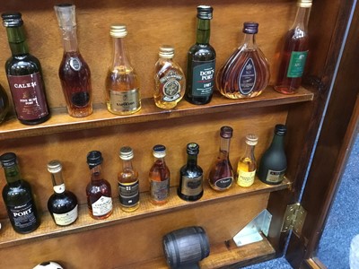 Lot 135 - Collection of miniature spirits in wall cabinet.