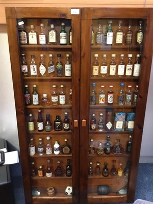 Lot 135 - Collection of miniature spirits in wall cabinet.