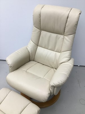 Lot 76 - Cream leather easy chair and footstool