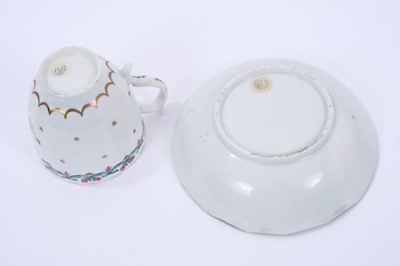 Lot 60 - Lowestoft coffee cup and saucer, of faceted form with a scrolled handle, the centre in pink and green with with a flower sprig within a gilded band, a 'Bungay' border enclosing a band of gilt stars...