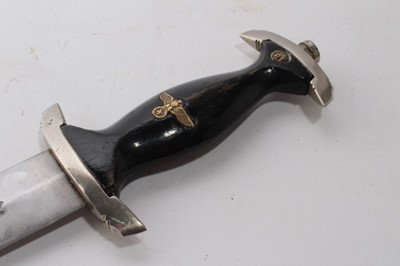 Lot 968 - Composite Nazi SS model 1933 dagger, later painted wooden grip and insignia, the blade etched 'Meine Ehre heist True', in black painted scabbard with nickel mounts.