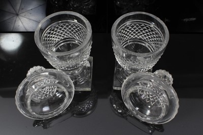 Lot 44 - Georgian cut glass butter tub and lid on stand, together with a pair of cut glass urns and covers