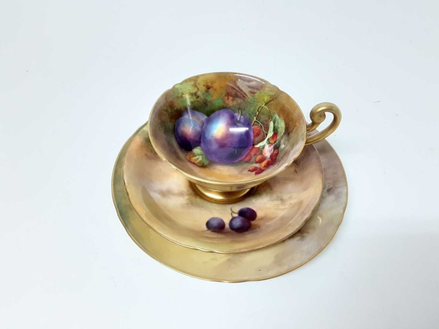 Lot 1144 - Good quality Royal Worcester fruit painted cup and saucer trio