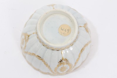 Lot 20 - Worcester fluted tea bowl and saucer, circa 1775-80, decorated in gilt with swags and other patterns, the saucer measuring 14cm diameter