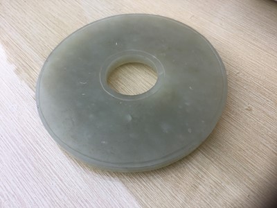 Lot 784 - Good Chinese carved jade figure, together with a carved jade bi-disc